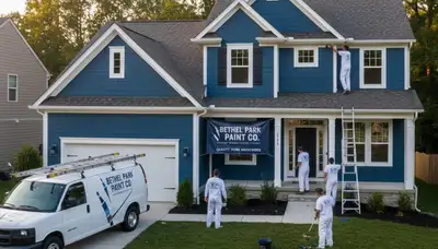 Professional house painters in Pittsburgh PA applying exterior paint to a two-story home